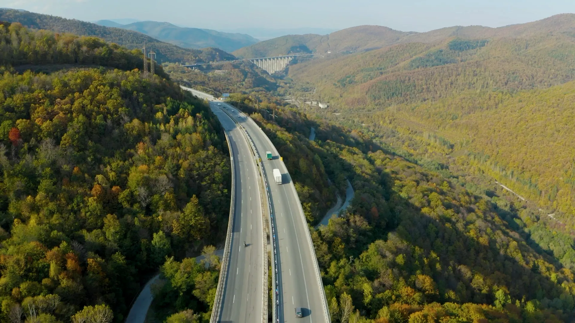 Aerial view of a motorway crossing a forested valley
